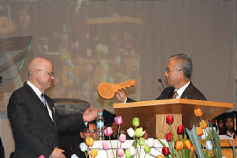 Elder Alfredo Miron, an Area Seventy and Benemerito's final director, presents a wooden "key to the