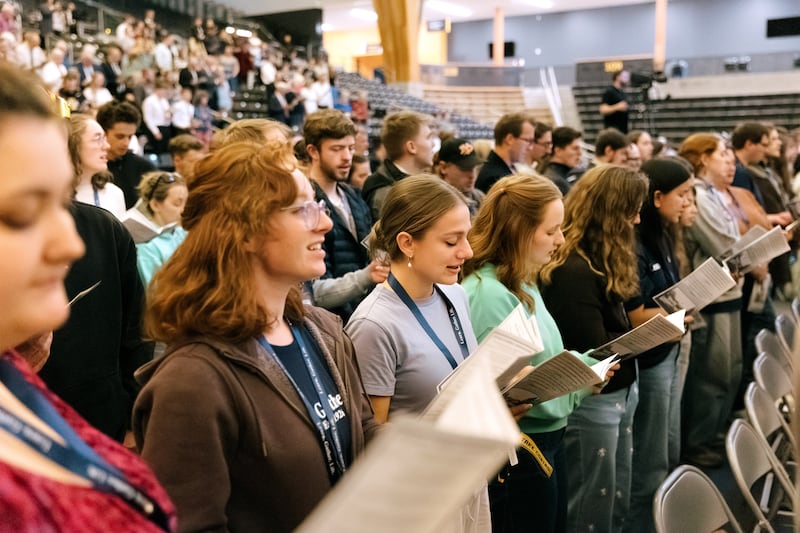 Young adults stand to sing during a "100 years of institute" commemorative devotional held in the ICCU Arena on the University of Idaho campus in Moscow, Idaho, on Saturday, Sept. 26, 2026.