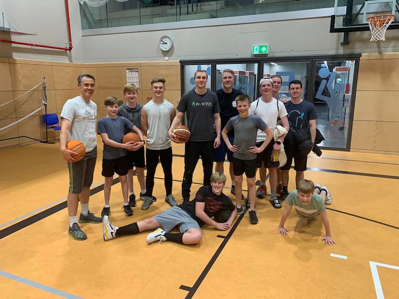 Parker Van Dyke, center, hosts a basketball clinic for the young men in the Bitburg Ward of the Kaiserslautern Germany Stake in 2023.