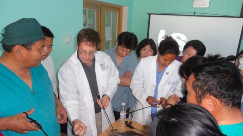 Dr. Raymond R. Price, second to the left, shows laparoscopic instruments to surgeons in the Advanced Trauma Life Support (ATLS) program in Mongolia, which started in June 2015.