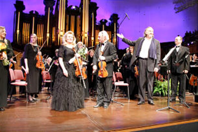 Artists acknowledge applause from audience. From left, with Orchestra at Temple Square in background