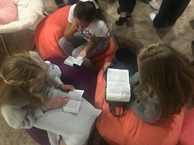 A trio of girls read from their scriptures as part of a weekly student-led scripture study group in Draper, Utah.
