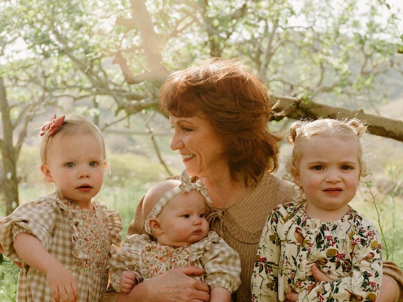 Tammy Simister Robinson takes a picture with her three granddaughters in 2022.