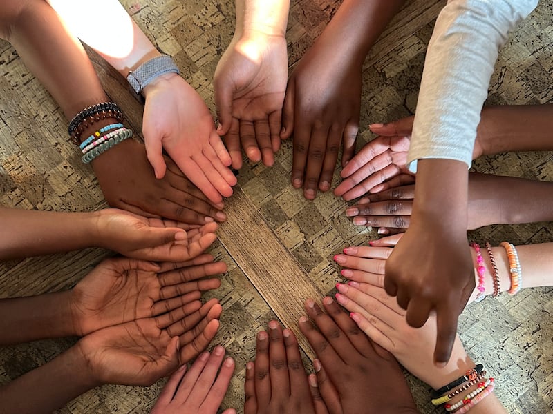 16 hands are shown in a circle during girls camp of the Treasure Valley Branch (Swahili) in Boise, Idaho, June 5, 2025.