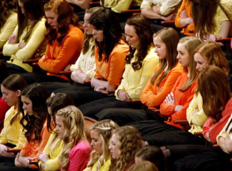 Choir members pause during the invocation at the annual General Young Women Meeting in the Conferenc