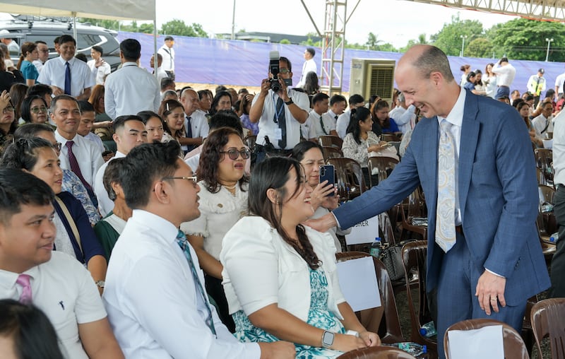 Elder Steven D. Shumway — a General Authority Seventy and member of the Philippines Area presidency, right — greets guests and attendees at the groundbreaking of the Naga Philippines Temple on Aug. 8, 2026, in Naga City, Philippines.