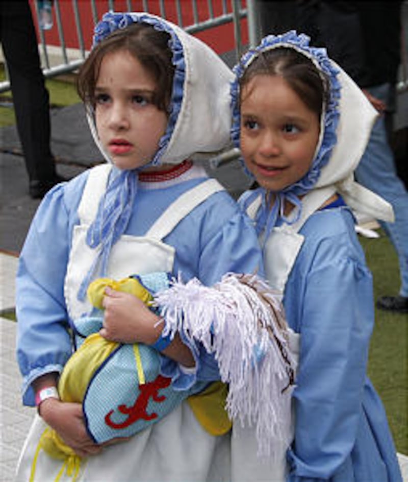 Two young Brazilian girls in costume await their opportunity to perform in cultural event that was p