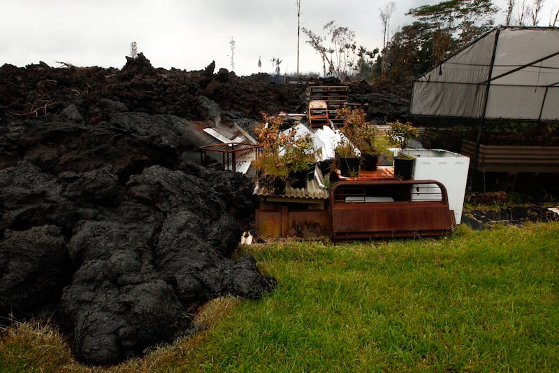 Lava overruns property along Hookupu Street, Monday, May 7, 2018, in Pahoa, Hawaii. Hawaii's Kilauea