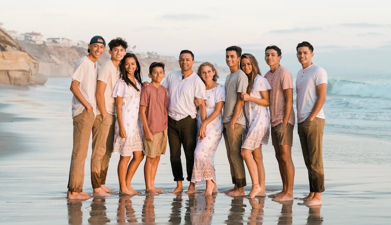 The Guanuna family poses for a photo on the beach in Southern California in 2022.