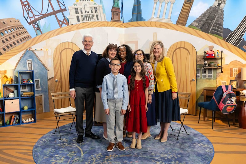 Elder and Sister Caussé and the Primary general presidency take a picture with two child hosts during the filming of the September 2026 Friend to Friend broadcast.