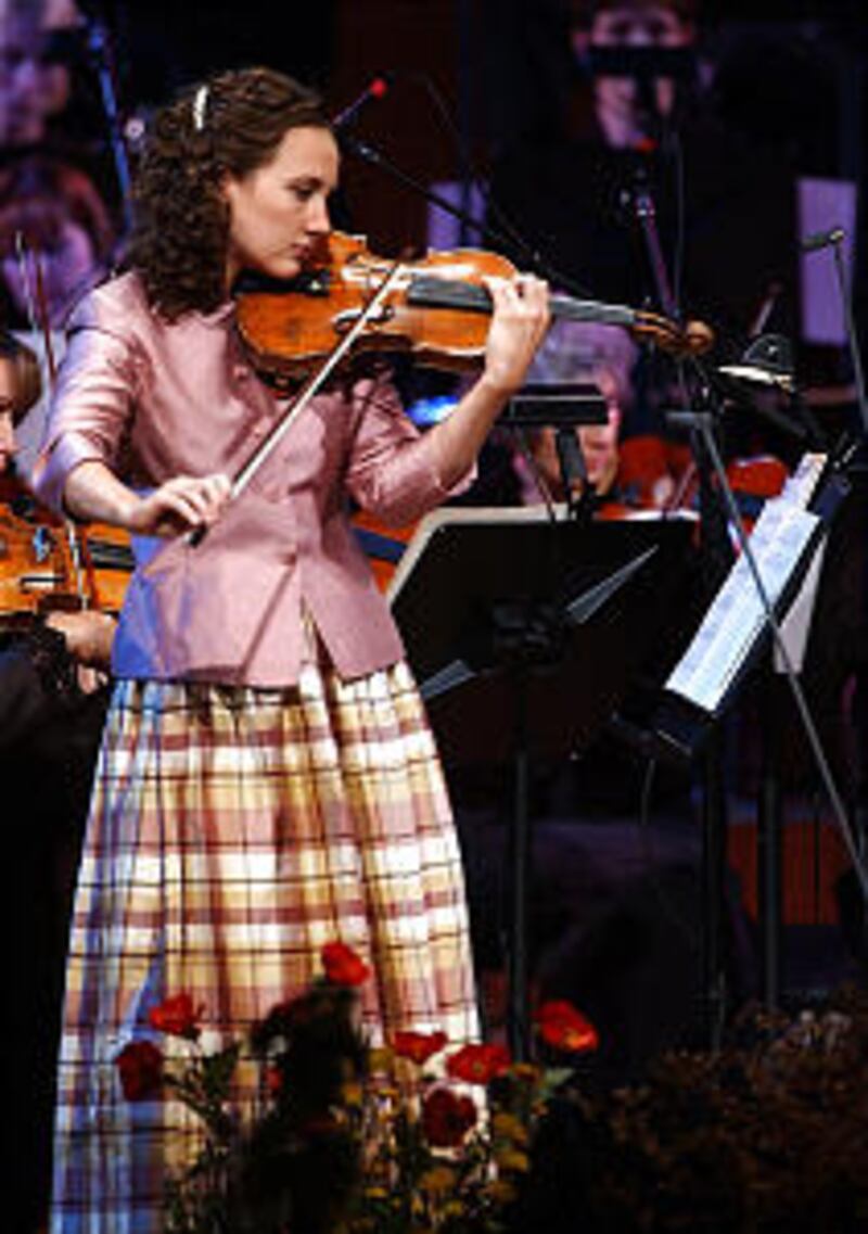 Jenny Oaks Baker plays the violin with the Tabernacle Choir and the Orchestra at Temple Square perfo