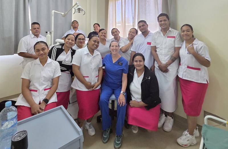 Kathleen Young, in blue, smiles with her dental students in the clinic at Vaiola Hospital in Nuku’alofa, Tonga, in March 2026.