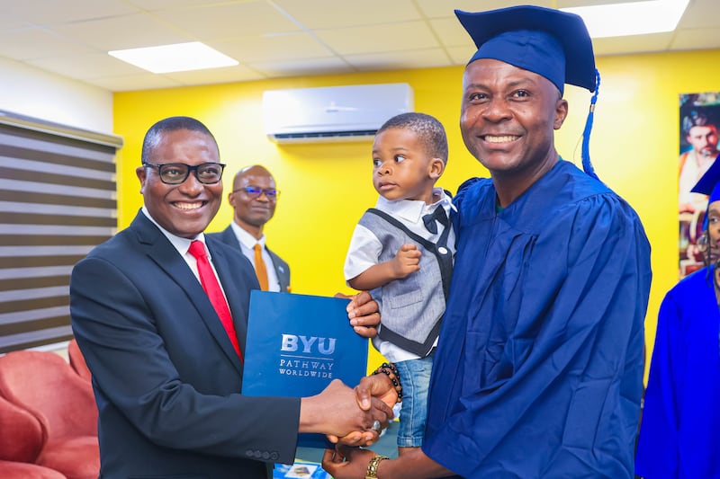 Elder Adeyinka Ojediran shakes hands with a student who completed a BYU–Pathway program at the completion ceremony in Lagos, Nigeria, Dec. 11, 2025.