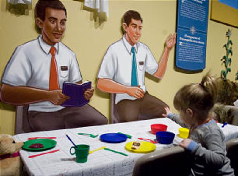 Jordin Hymas "prepares" a meal for a pair of hungry missionaries in a section of the new exhibit "A