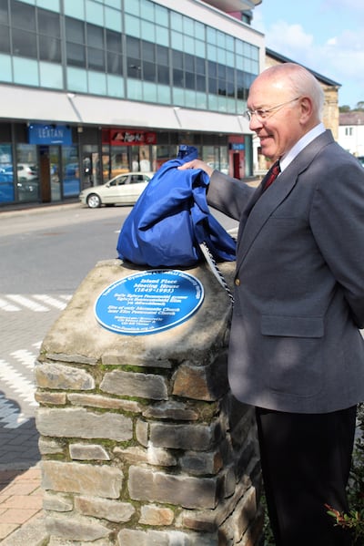 Dr. Ronald Dennis unveils the blue plaque to commemorate the historic Church building known as the Island Place Meeting House on Aug. 25, 2018, in Llanelli, Wales.