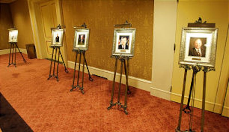 Photos of former Distinguished Utahn award recipients lined the walls of a banquet room during this