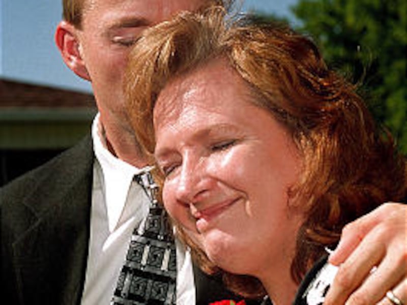 Nathan Wahlstrom soothes his mother, Margaret Wahlstrom, following services for her mother, Mary Ali