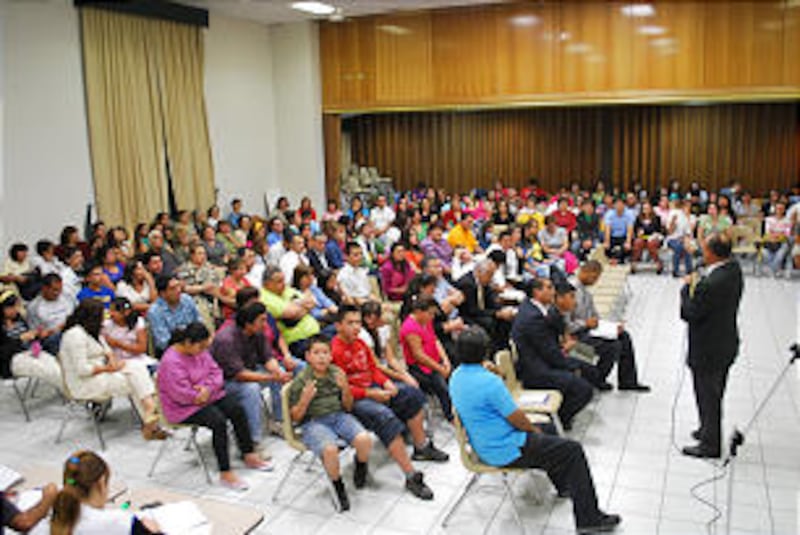Members gather in a meetinghouse to receive direction and comfort following the earthquakes that lef
