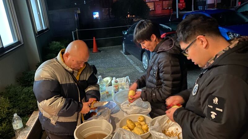 Two full-time missionaries and a man slice potatoes for a meal for earthquake evacuees in Ishikawa Prefecture, Japan.