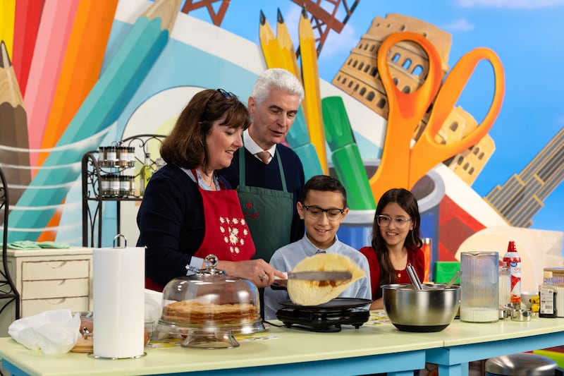 Elder Gérald Caussé and Sister Valérie Caussé, make crêpes with two child hosts during the September 2026 Friend to Friend broadcast.