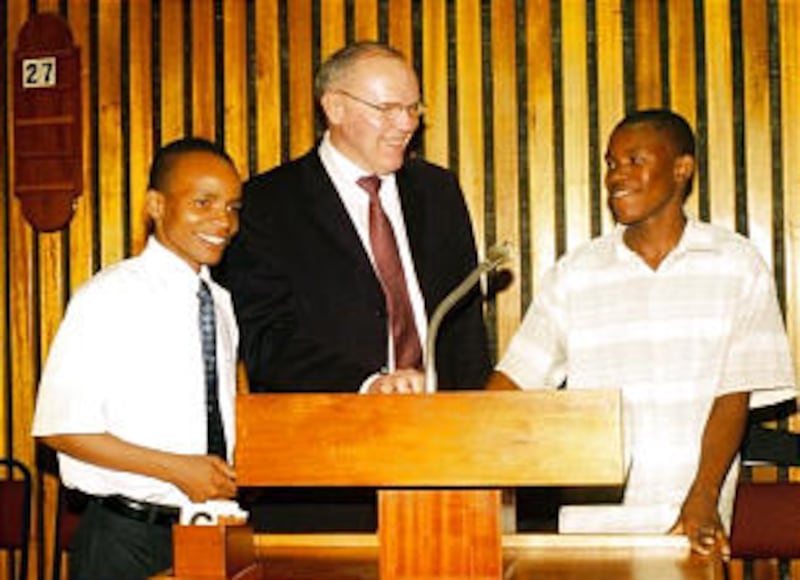Sunday School General President Russell T. Osguthorpe enlists two young men to help with his trainin