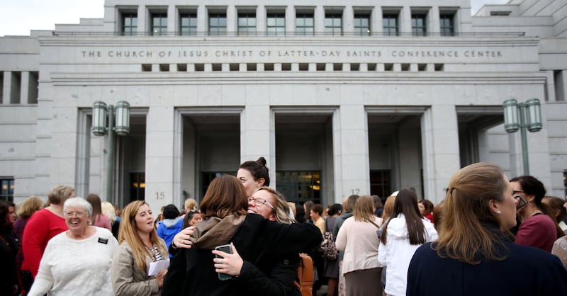Women gather outside before the start of the general women's session of the 188th Semiannual General