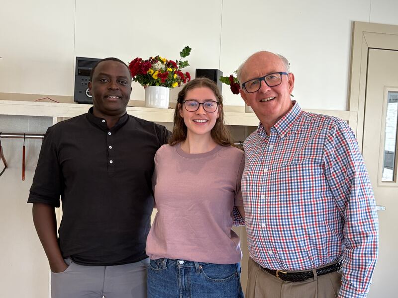 Boston College student Elise Jarvis takes a picture with two professors in Cambridge, Massachusetts, Sept. 29, 2025.