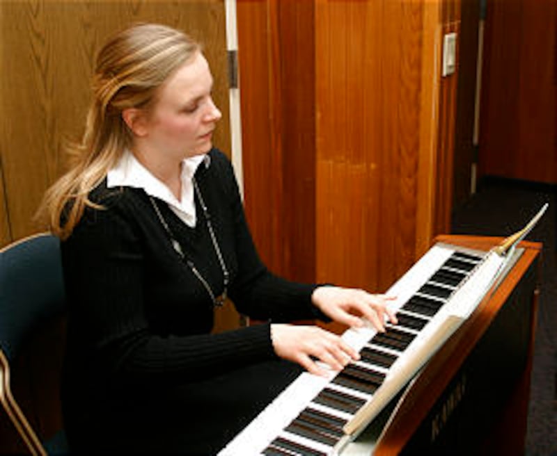 Carla McClenegan accompanies the Banff Branch Primary during music time. Numerous visitors benefit f
