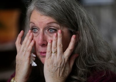 Diane Kienholz wipes tears from her eyes while talking about her work with the homeless population at home in Puyallup, Wash., on Sunday, Jan. 26, 2020.