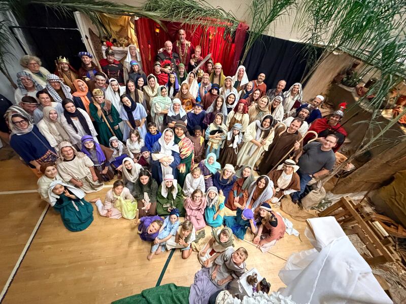 Dozens of volunteers and cast for the Bethlehem Walk take a photo together at the Escondido California Stake Center.