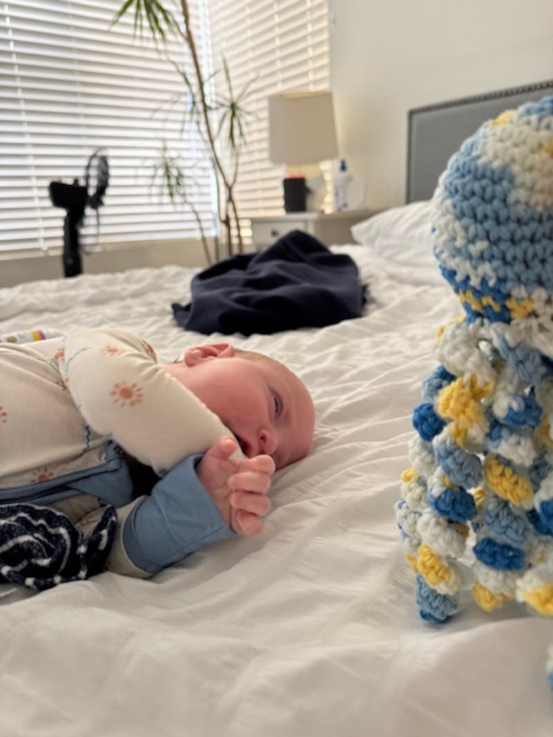 Ben Morris, Lynda Morris' grandson, reaches for an octopus crocheted by Lynda Morris on Nov. 13, 2025, in San Clemente, California.
