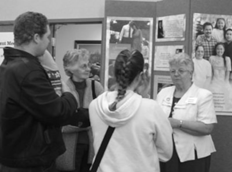 Darlene Bonnett, wife of Branch President Austin Bonnett, talks with visitors at open house of new m