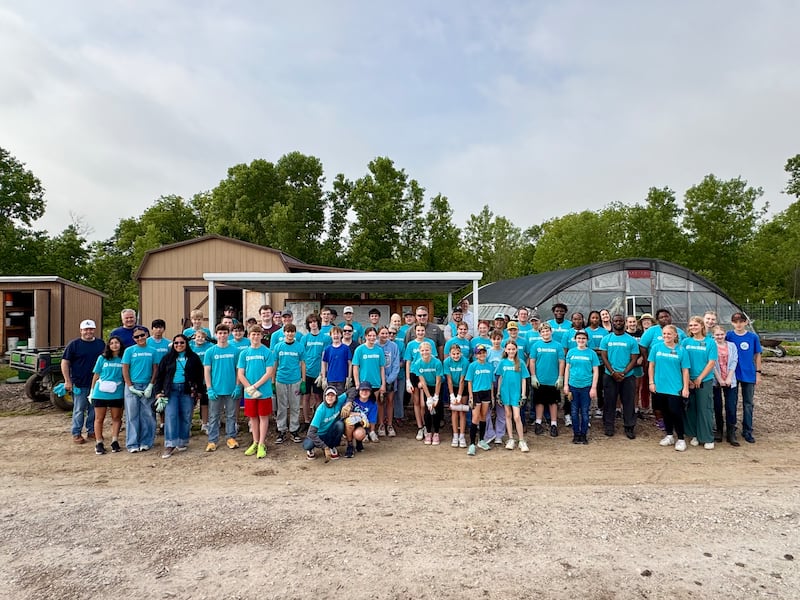 Member of The Church of Jesus Christ of Latter-day Saints and Mount Zion Praise Church smile for a photo after helping out at the Shiloh Gardens in Denton, Texas,on April, 25, 2026.
