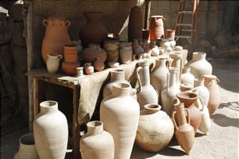 Various types of pottery are displayed at a stall meant to resemble a pottery street vendor in Jerus
