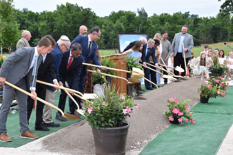 Elder Aroldo B. Cavalcante, fifth from left, join others for the ceremonial turning of the soil at the groundbreaking of the Springfield Missouri Temple.