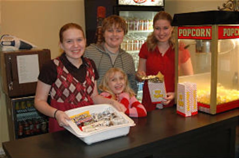 Snacks At the Plaza Theatre in Cleburne, Texas, the Barrus and Siler children pitch in by popping po