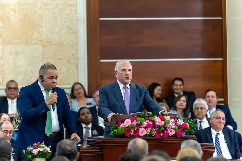 With the assistance of an interpreter, Elder Ronald A. Rasband of the Quorum of the Twelve Apostles speaks to a gathering of more than 800 missionaries.