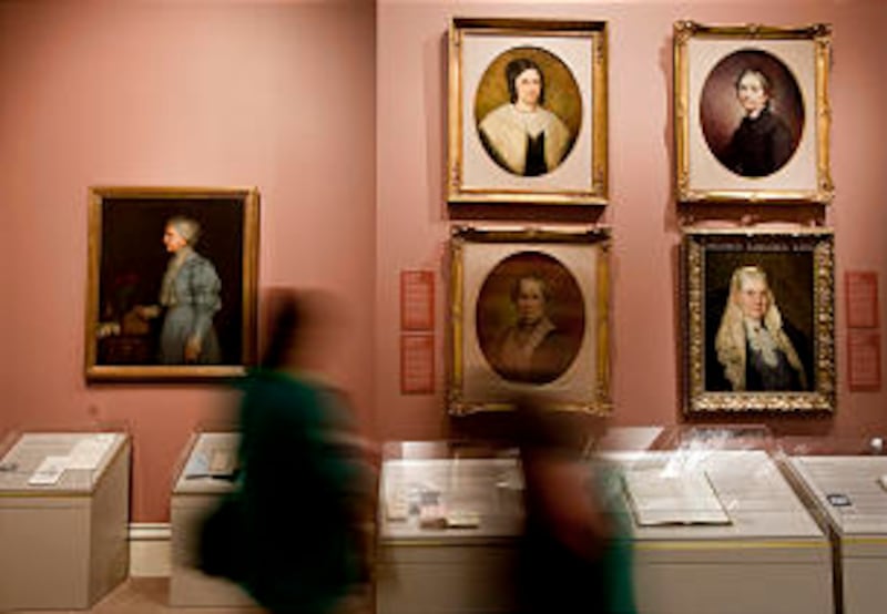 Visitors to the Church History Museum pass by a permanent exhibit on the Relief Society at the museu