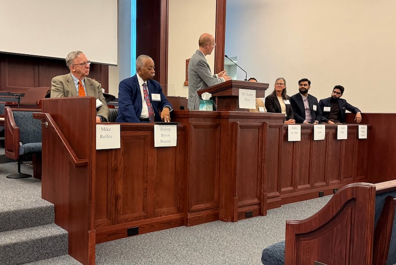 Speakers sit on the stand together at an interfaith gathering in Chicago, Illinois, on Oct. 14, 2026.