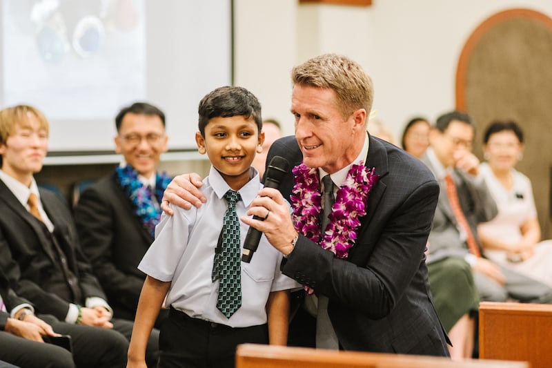 Young Men General President Timothy L. Farnes interacts with a youth during a devotional. President Farnes ministered to youth and members in Cambodia, Singapore and Malaysia from May 21-31, 2026.