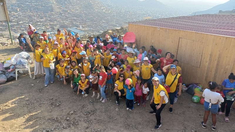 Primary children from the Lima Peru Comas Stake smile with other children in the Los Coyes community after a Primary service activity on Oct. 6, 2026.