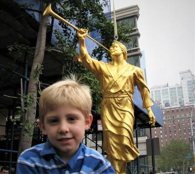 Isaac Draper in front of the Angel Moroni in New York City while visiting with his mom.