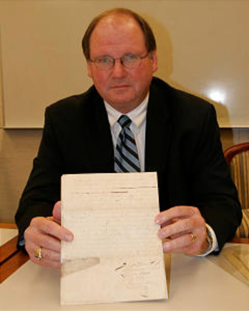 Ron Barney, a volume editor in the project, holding the actual manuscript of Joseph Smith’s epistle