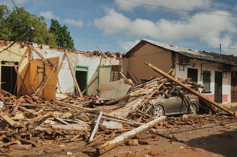 A car is covered in rubble from houses damaged by an earthquake in Villa de los Santos, Panama, Saturday, Oct. 10, 2026.