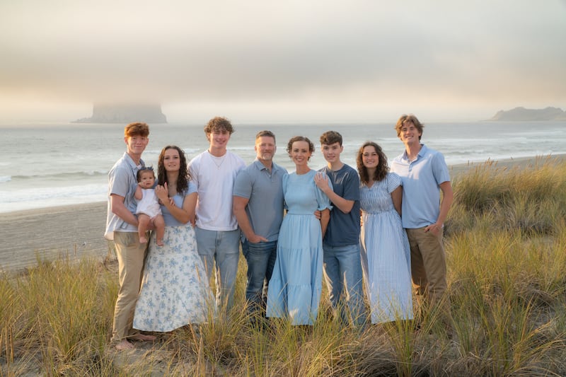 Nine members of the Anglesey family takes a photo together while on a trip to Pacific City, Oregon, in September 2025.
