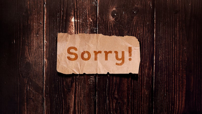 Sorry! on paper on a wooden background.