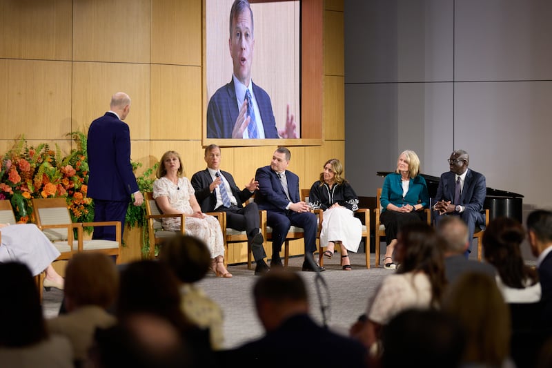 Elder Dale G. Renlund (left) speaks to panel discussion participants at the 2026 New Evangelist Seminar.