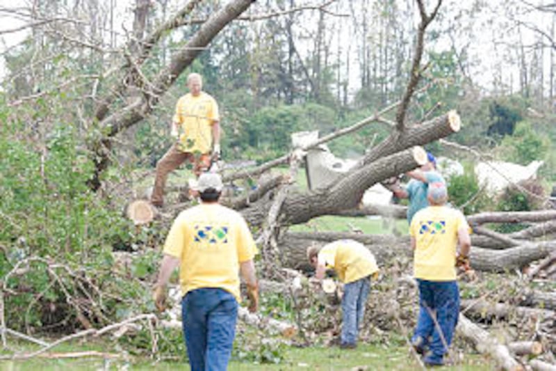 Church members wearing helping hands shirts volunteer time and effort after devastating tornado dest