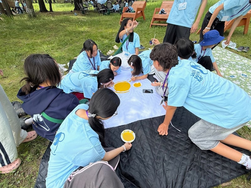 Participants at a For the Strength of Youth Conference near Ulaanbaatar, Mongolia, create a team flag on June 28, 2026.