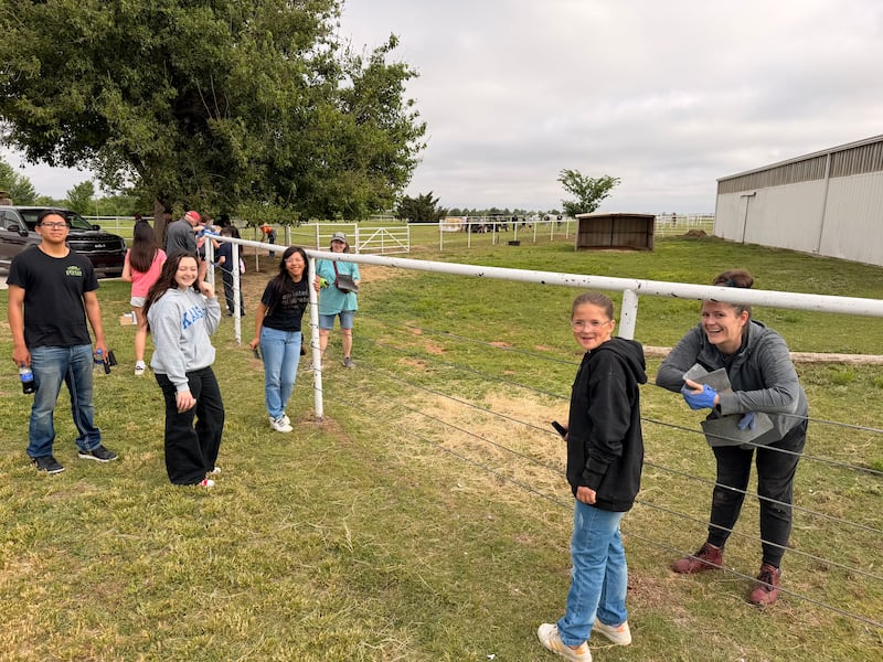 Youth volunteers paint a fence at the Savannah Station Therapeutic Riding Program in Yukon, Oklahoma, for Global Youth Service Day in April 2026.